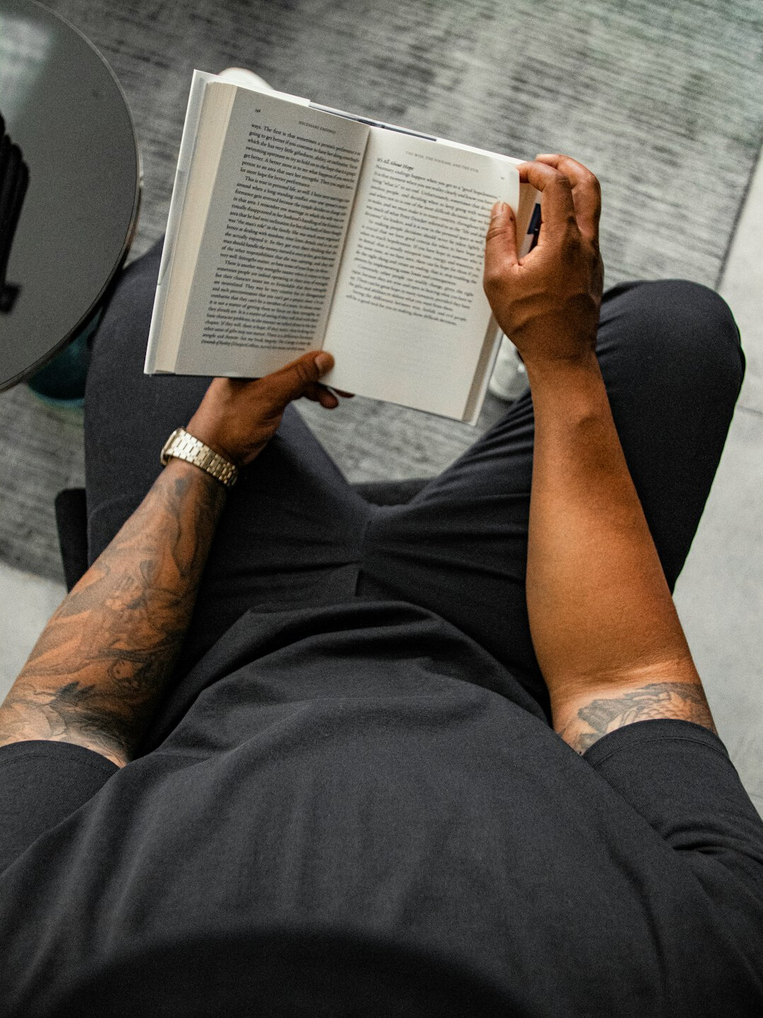 person reading book at home
