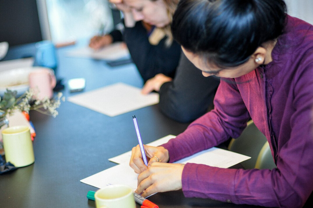 woman taking notes in workshop